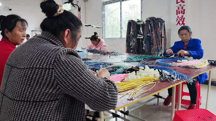 图2 灵活就业人员在线束项目生产线上忙碌着.jpg