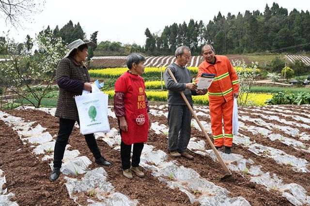 图2  夏开桂夫妻俩在向村民宣传森林防火知识.jpg