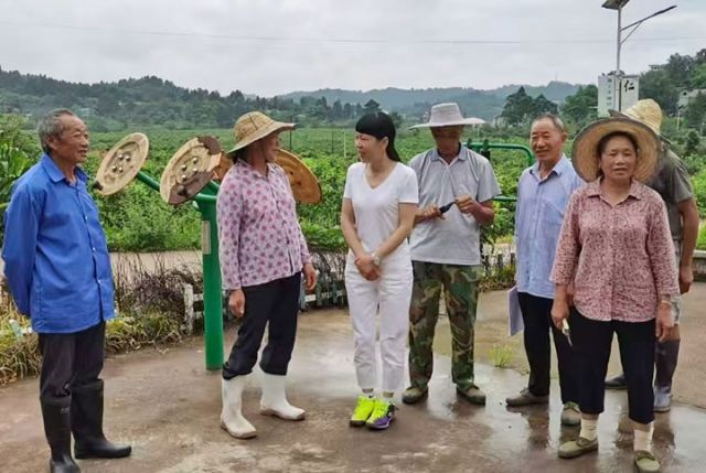 图1  蒙雪梅（左三）和村民们交谈。安岳县人大 供图.jpg