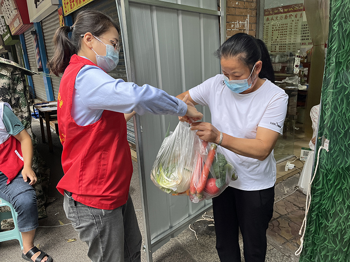 泸州农商银行志愿者为管控区域群众送生活物资.jpg